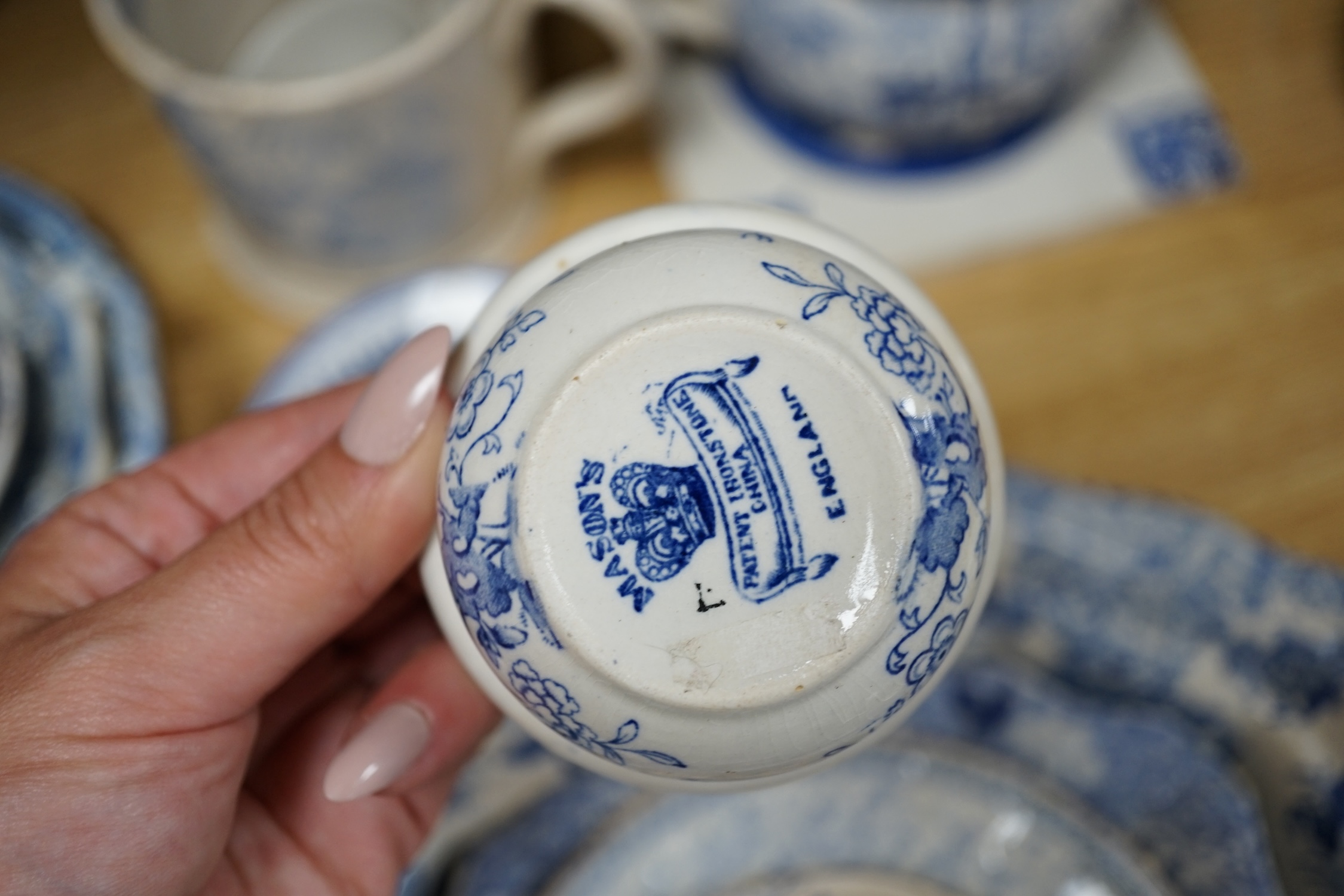 A collection of mixed blue and white dinnerware including Masons Ironstone, mostly plates and jugs. Condition - varies, poor to fair